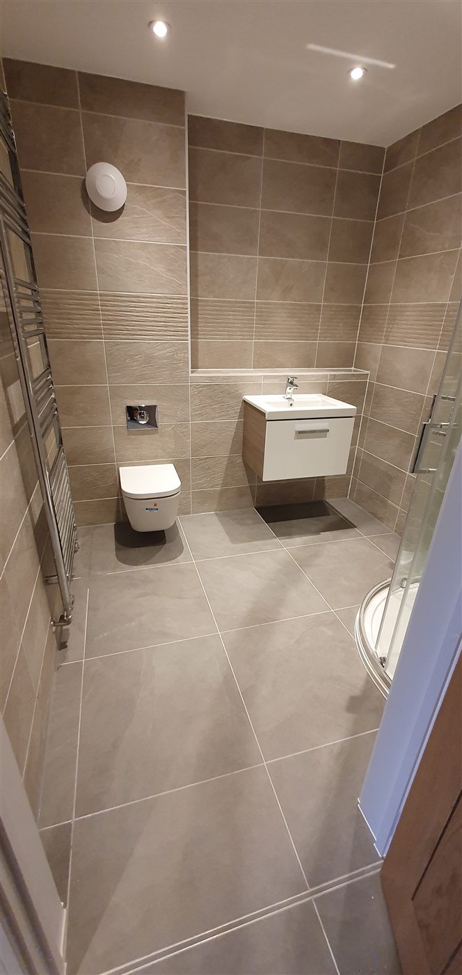 Neutral tiled bathroom walls and floor